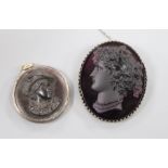 A metal mounted amethyst paste cameo carved with the bust of a lady to dexter and a tortoiseshell