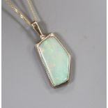 A modern yellow metal and shaped white opal set pendant, on a 9ct fine link chain, pendant 23mm.