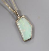 A modern yellow metal and shaped white opal set pendant, on a 9ct fine link chain, pendant 23mm.