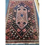 A Caucasian pink ground rug 175 x 115cm