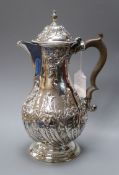 A George III silver hot water pot with later embossed decoration, Charles Wright, London, 1776,