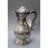 A George III silver hot water pot with later embossed decoration, Charles Wright, London, 1776,