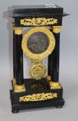 An ebony and gilt portico clock H.40cm