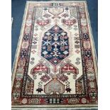 A Kazak style fawn ground rug Approx. 160 x 100cm