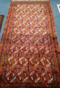 A Bokhara red ground carpet 260 x125cm