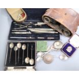 A pair of military binoculars, badges, a compass, two silver spoons etc