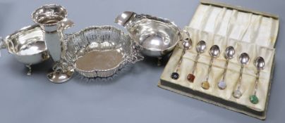 A pair of George V silver sauceboats, a pierced silver two handled dish, a silver vase and cased set