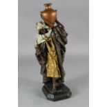 A Goldscheider style painted plaster figure of an Arab water carrier, H.40in.