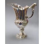 A George V silver ewer, with embossed foliate scroll motifs, Harman & Co, London, 1925, 25.5cm, 24.5