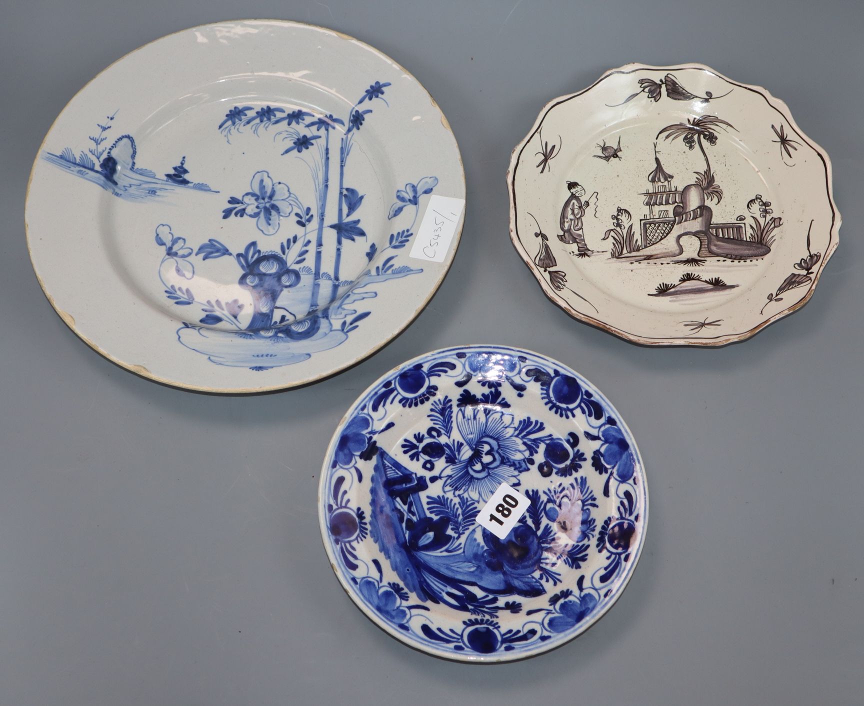 A Bristol Delft charger, a dish and a plate largest diameter 30cm