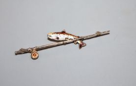 An early 20th century 9ct, silver and enamel 'trout and fishing rod' bar brooch, 62mm.