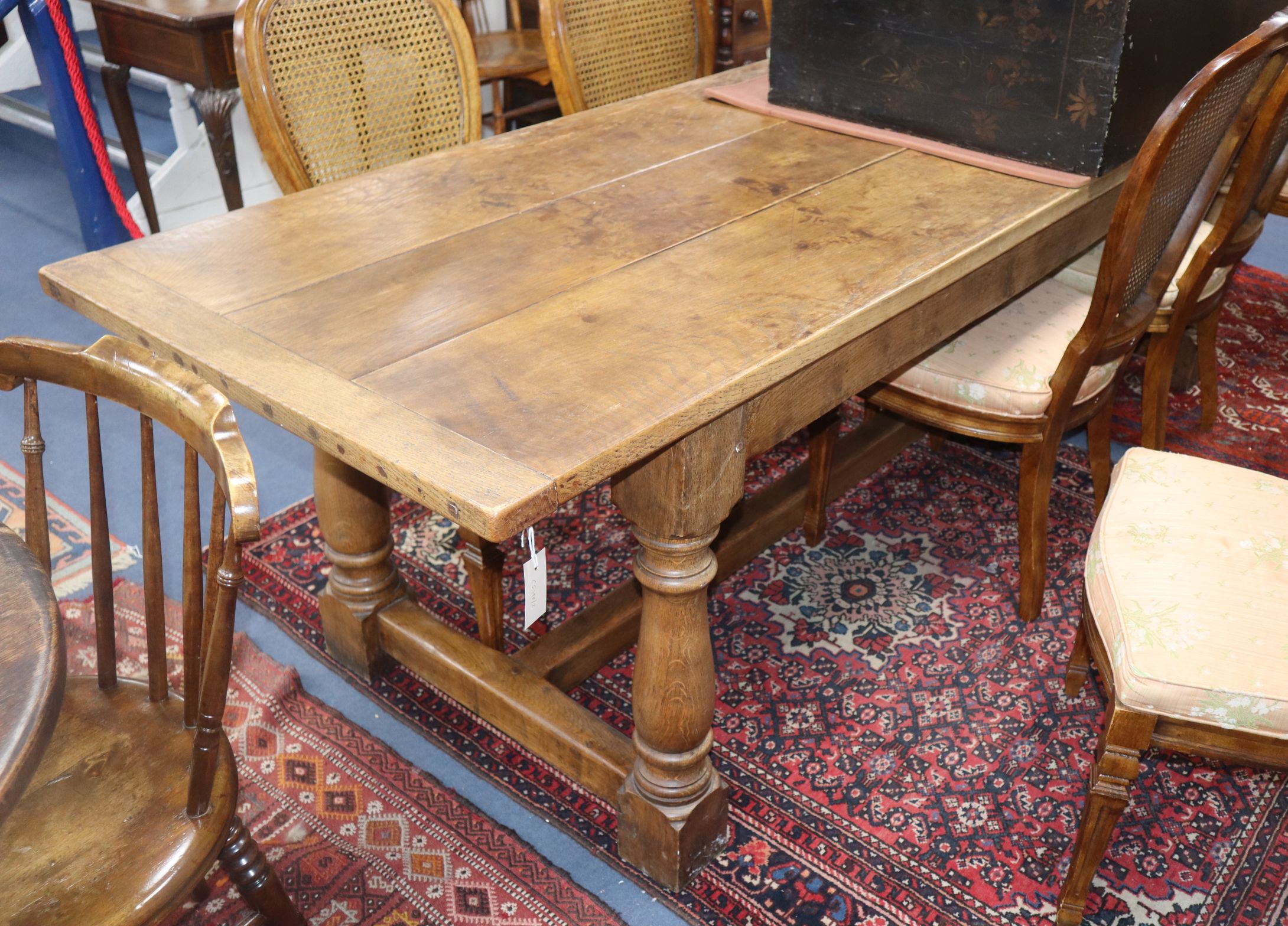 An 18th century style oak refectory dining table L.252cm