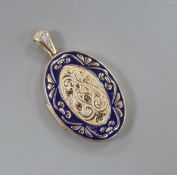 A yellow metal and enamel oval locket with diamond set bale, overall 48mm.