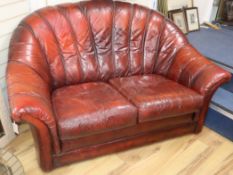 A pair of Tetrad 1970's burgundy leather two seater sofas W.150cm