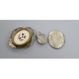 A Victorian gilt metal mourning brooch, inset an ivory panel carved with ghostly features, vacant
