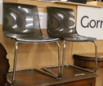 A pair of smoked perspex and chrome cantilever chairs