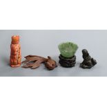 A Chinese stained coral snuff bottle modelled as a shrew, a nephrite bowl, a bronze figure, a fish