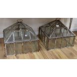 A pair of Victorian iron and class cloches