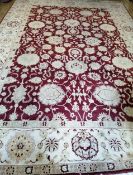 An Agra red ground carpet 410 x 290cm