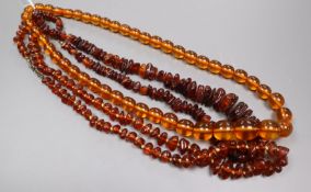 Three assorted clear amber bead necklaces.