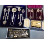 A silver toast rack, assorted silver and plated teaspoons and a bedside alarm timepiece