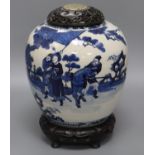 A large Chinese blue and white jar, Kangxi mark, 19th century, the wood cover inset with a jade