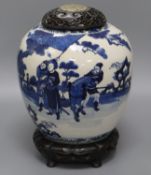 A large Chinese blue and white jar, Kangxi mark, 19th century, the wood cover inset with a jade