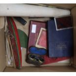 A postcard album, cigarette cards, opera glasses and sundries