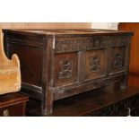 An 18th century carved oak panelled coffer W.126cm