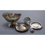 A Victorian silver boat shaped sugar basket, a similar sifter spoon and two white metal dishes.