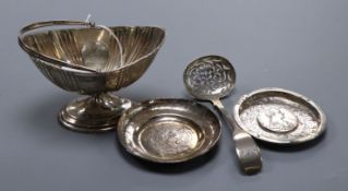 A Victorian silver boat shaped sugar basket, a similar sifter spoon and two white metal dishes.