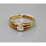 A late Victorian 18ct gold and claw set solitaire old round cut diamond ring, the stone weighing