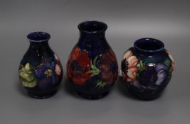 Three small Moorcroft Anemone pattern blue ground vases, each with impressed/painted marks, H