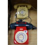 A red cream and blue Rotary phone and another