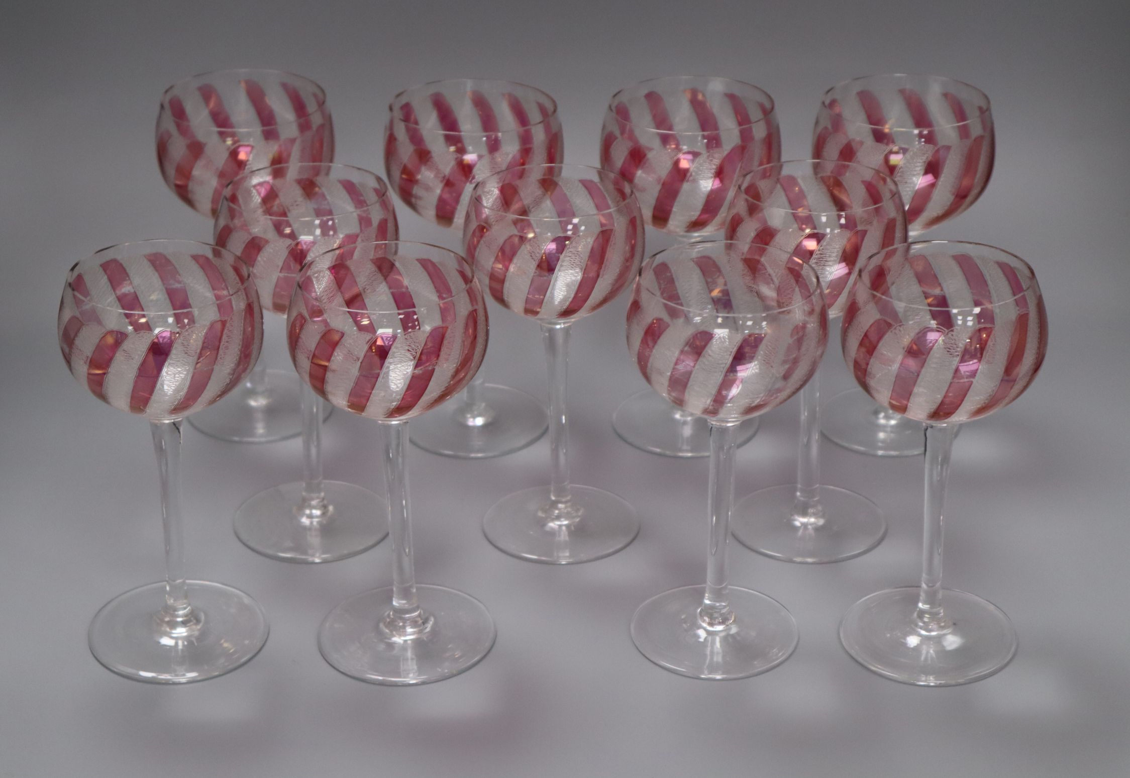 A set of eleven cranberry and etched wine glasses