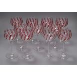 A set of eleven cranberry and etched wine glasses