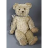 A 1920's English bear, with glass eyes, 19in., good mohair, original paw pads