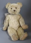 A 1920's English bear, with glass eyes, 19in., good mohair, original paw pads