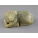 A Chinese celadon and russet jade figure of a recumbent ox, late Qing dynasty, L.8cm