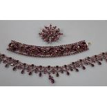 A suite of purple paste jewellery, comprising bracelet, necklace and brooch