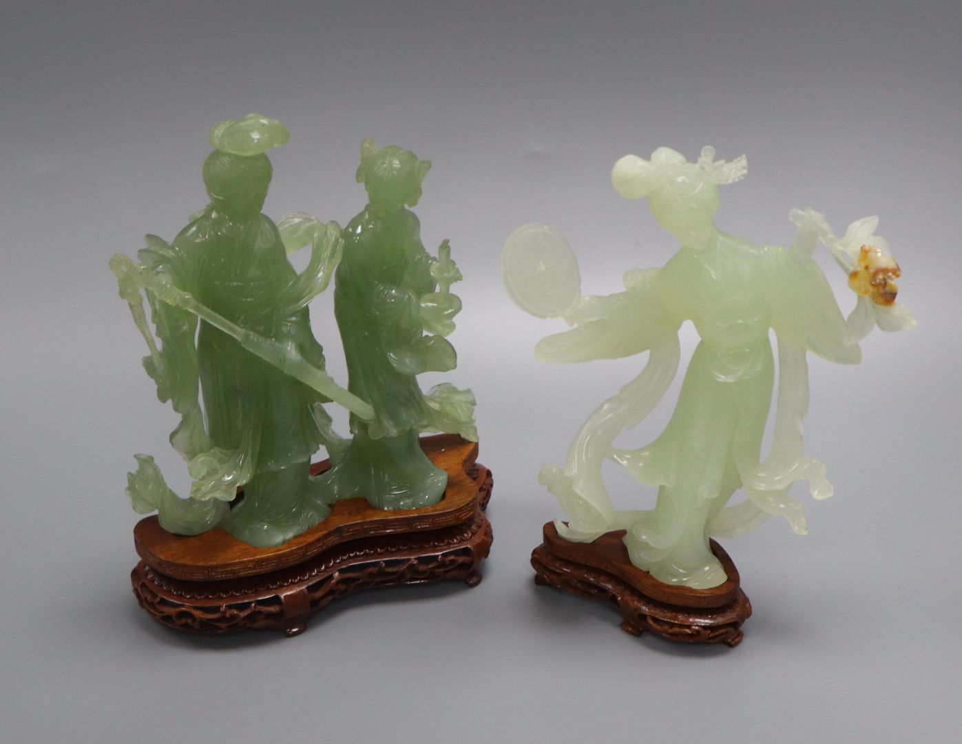 A 20th century Chinese carved bowenite jade figure of a courtesan and a similar group of a noble