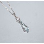 A modern Swedish 18ct white metal, diamond and shaped aquamarine set pendant, on a 750 fine link