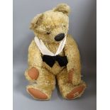 A large Chad Valley bear, foot label, very good condition, small tear to left paw pad, glass eyes,