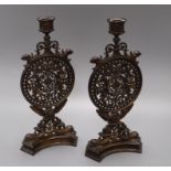 A pair of decorative pierced metal candlesticks 32cm