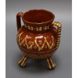 A 19th century Sussex slipware pottery tripod vase height 15cm