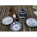 A pair of Chinese blue and white dishes and another, 18th century, a carved deity and a dragon vase