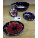 A Moorcroft Anemone small bowl, a similar pin dish, a small Hibiscus vase and a Clematis pin dish (