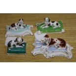 Four Staffordshire porcelain recumbent figures of three spaniels and a setter, c.1835-50, the