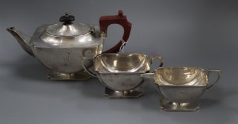 A George VI Art Deco three piece silver boat shaped pedestal tea set, I.S. Greenberg & Co,