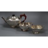 A George VI Art Deco three piece silver boat shaped pedestal tea set, I.S. Greenberg & Co,